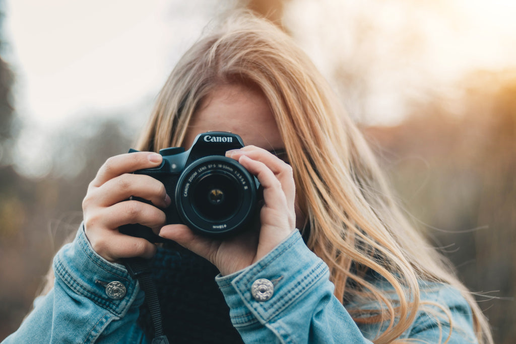 Woman taking a photo to demonstrating the importance of lifestyle photography for Amazon listing optimization