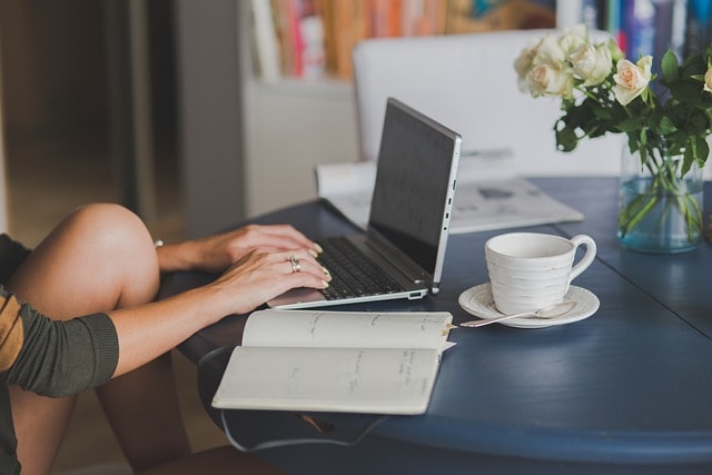 woman typing on her laptop to improve her ecommerce website with relevant keywords and drive sales